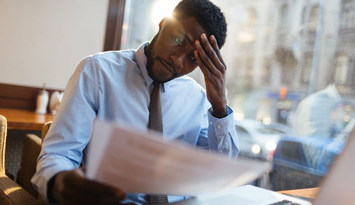 african american man stressed and dealing with depression at work