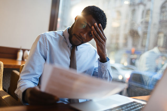 african american man stressed and dealing with depression at work